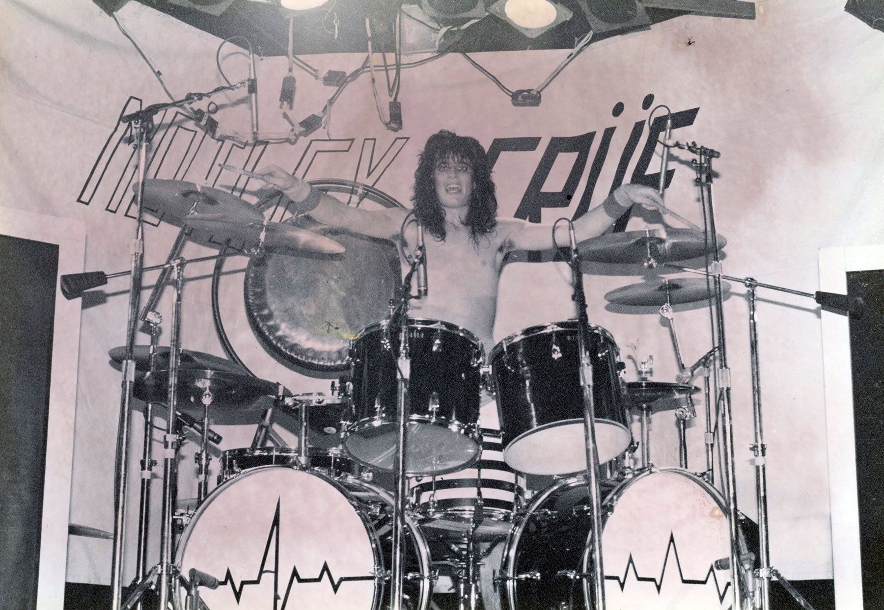 Tommy Lee in front of a Motley Crue bedsheet for an LA crowd 1981